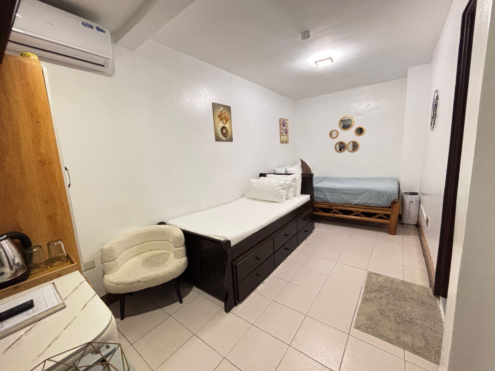 two beds pictured with the whole room